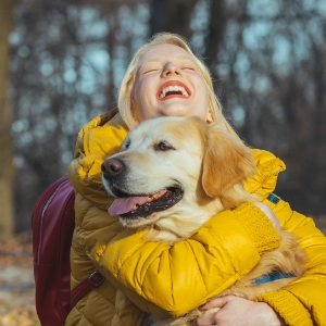 Woman hugging a dog.
