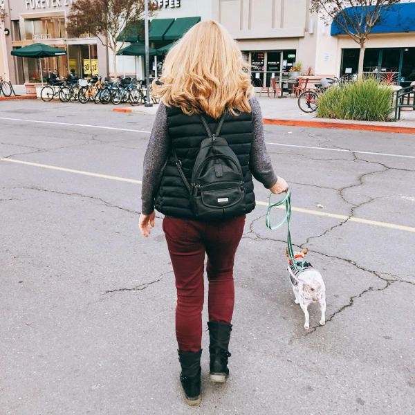 Lady walking a dog.